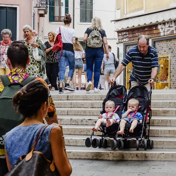 Twins in a stroller on a bridge in Venice, Italy.