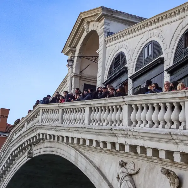 Visitors look at Venice's Grand Canal from the Rialto Bridge.