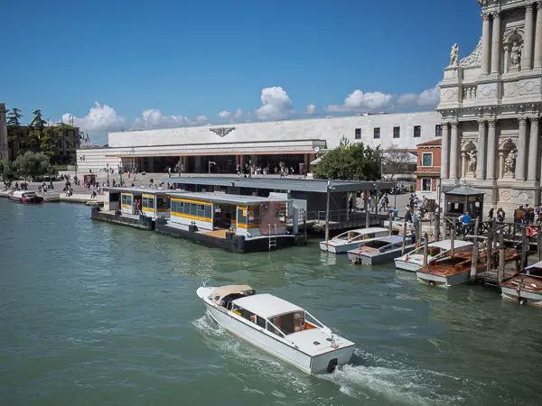 A water taxi cruises toward the Santa Lucia Railroad Station in Venice, Italy.