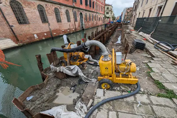 A cofferdam and pump on a canal in Venice, Italy.