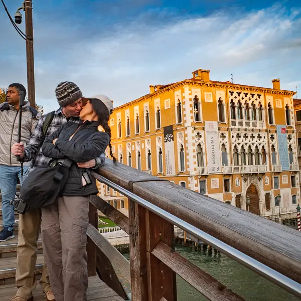 Visitors share a kiss on the Accademia Bridge in Venice, Italy.