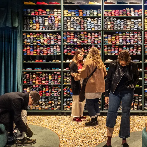Visitors shop for slippers at Piedàterre Venezia.