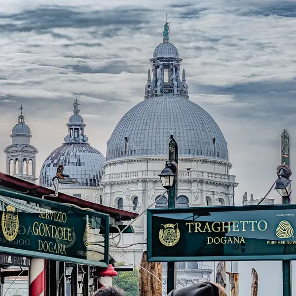 Signs identify the Dogana traghetto station near Venice's Basilica di Santa Maria della Salute.