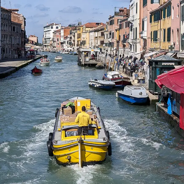 A delivery barge cruises on Venice's Cannaregio Canal.