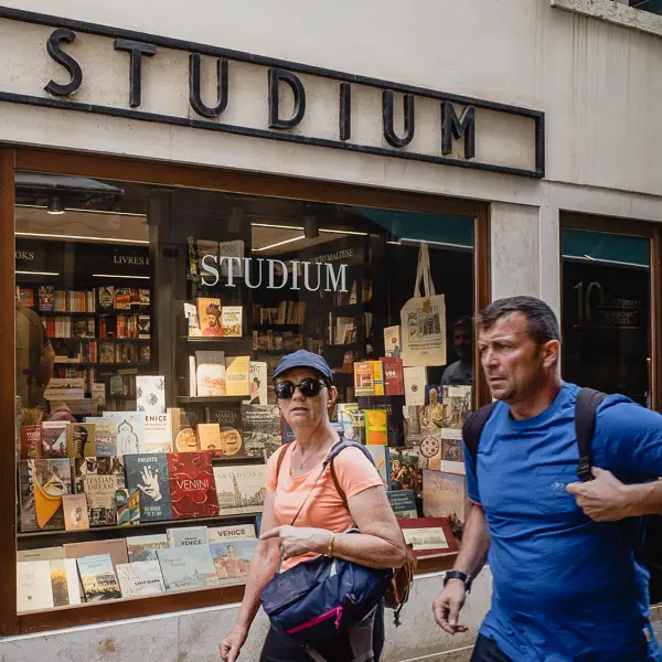 Visitors pass the Studium bookstore near the Piazza San Marco. (The shop has a good selection of English-language books.)