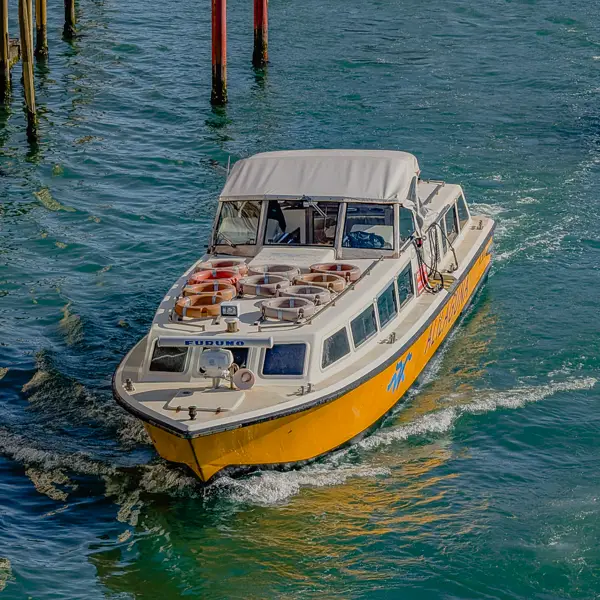 An Alilaguna Orange Line airport boat carries pasengers down Venice's Grand Canal.