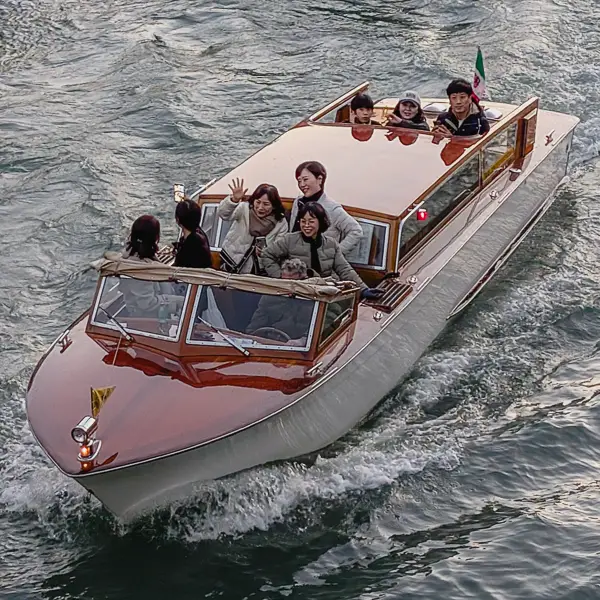 Visitors travel by water taxi on Venice's Grand Canal.