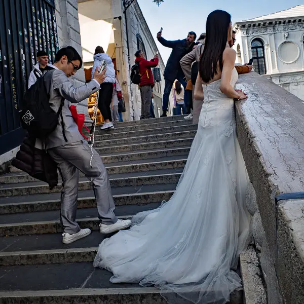 A bride poses for wedding photos on Venice's Rialto Bridge.