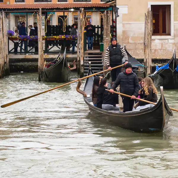 Two gondoliers row their traghetto from the Campo Santa Sofia to the Pescaria or Venice Fish Market.