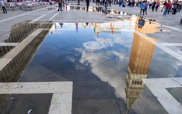 Water in Venice's Piazza San Marco with a reflection of the Campanile di San Marco.