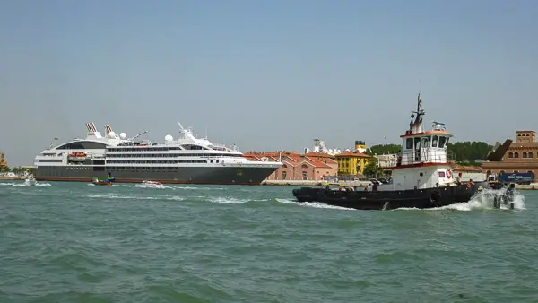 Compagnie du Ponant's AUSTRAL and a tugboat in Venice, Italy