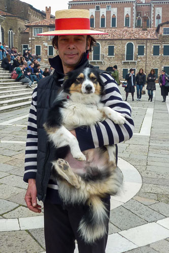 Gondolier with dog in Dorsoduro, Venice, Italy.