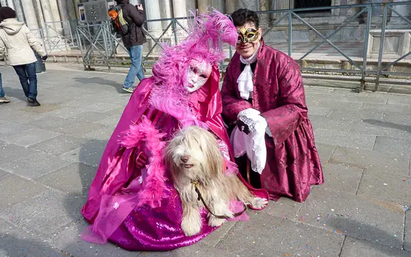 Maggie the Bearded Collie with Carnival performers in Venice.