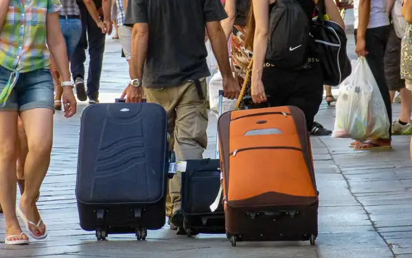 Tourists with suitcases in Venice.