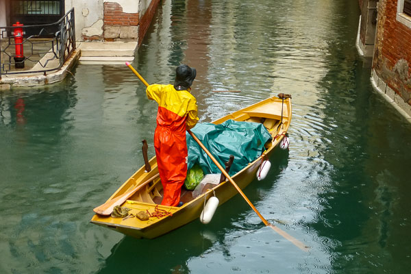 Venetian work boat in Venice side canal.