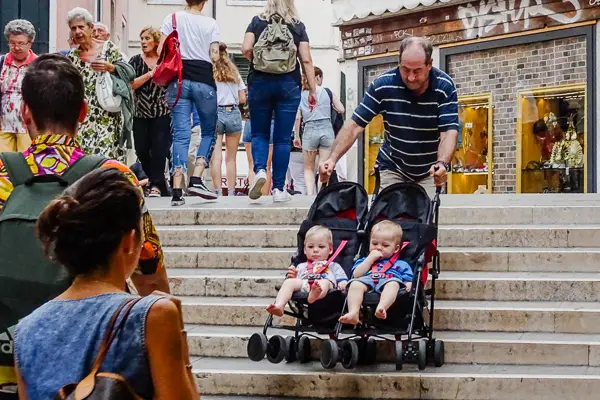 A stroller with twins on a bridge in Venice, Italy.