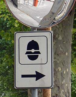 Traffic mirror and police station sign in Mestre Italy