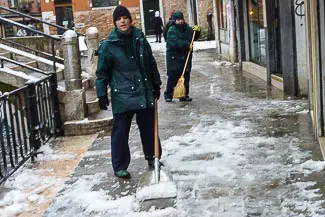 Shoveling snow in Venice, Italy